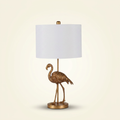 Matte Gold Flamingo Resin Table Lamp on a warm cream background