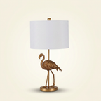 Matte Gold Flamingo Resin Table Lamp on a warm cream background