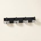 Modern 4-Light Matte Black LED Vanity Light Fixture With Crystal Glass on a warm cream background