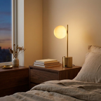 Ethereal Modern Small Brass Metal Table Lamp With White Glass Globe Sh styled in a warm modern interior