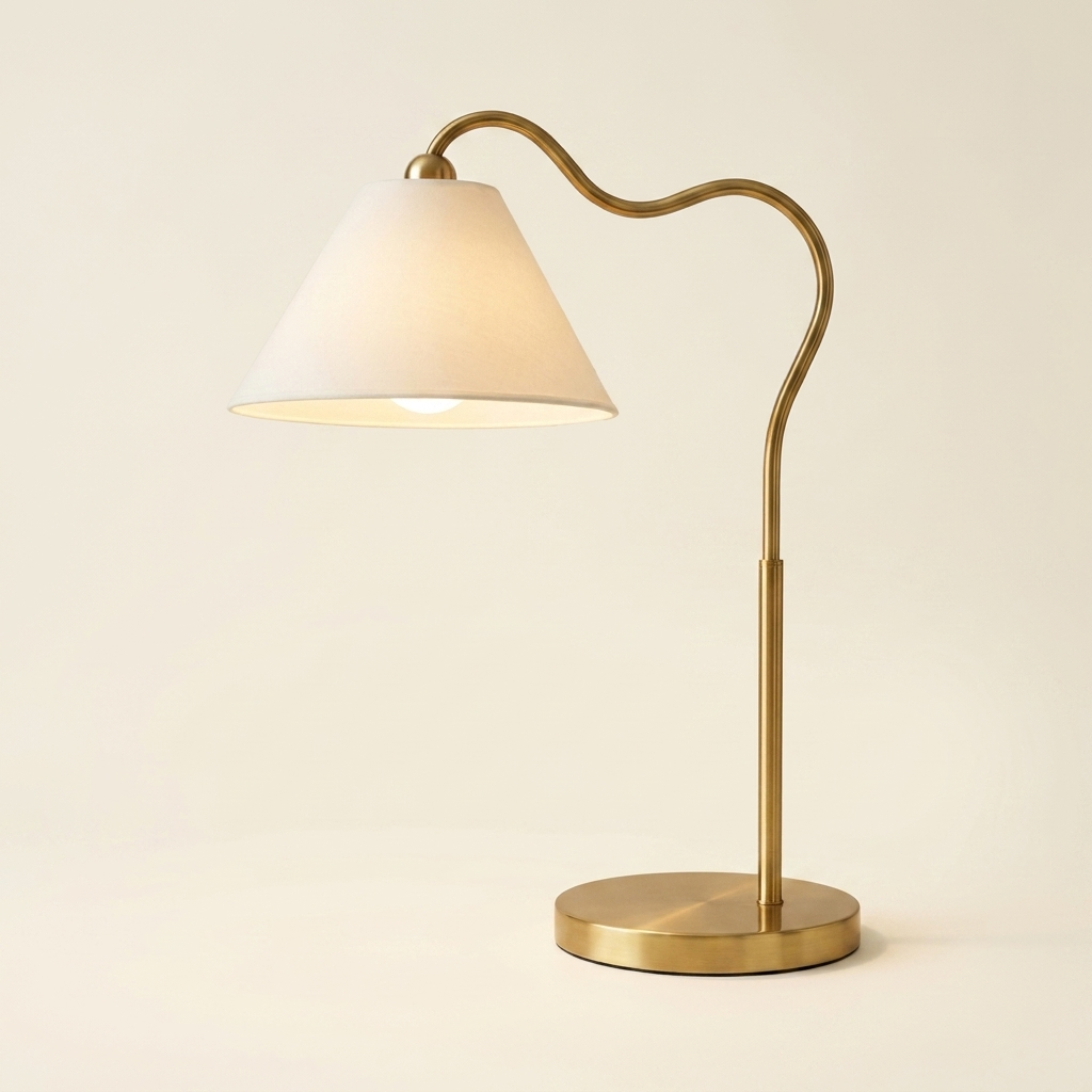 Ornate Brass Ring Base Curved Table Lamp With Triangle White Drum Shad on a warm cream background
